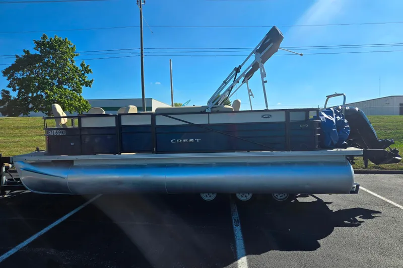 Slide: The Image of 2016 Crest II Fish 210 C4 pontoon boat parked on asphalt under clear blue sky. - 4