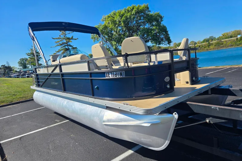 Slide: The Image of 2016 Crest II Fish 210 C4 pontoon boat on trailer by a lake. - 8