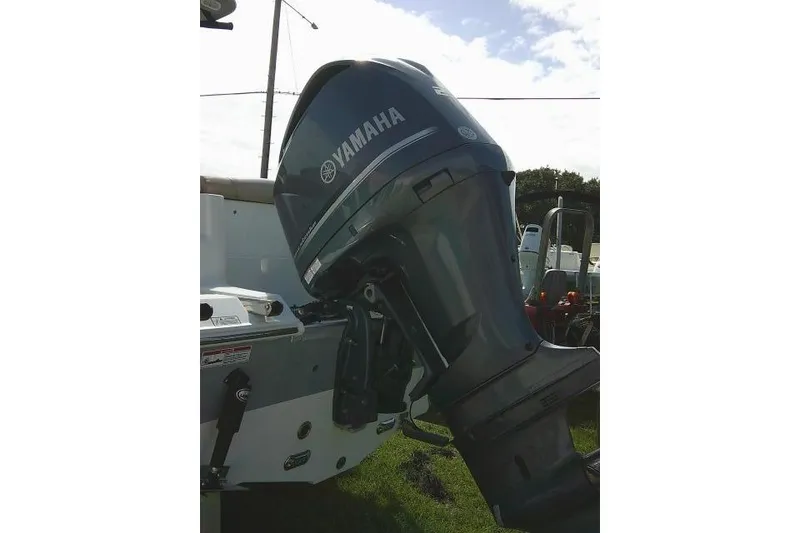 Slide: The Image of 2017 Sea Hunt Ultra 235 SE with Yamaha outboard motor, parked on grass. - 11