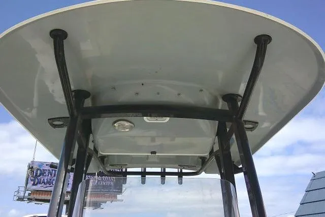 Slide: The Image of 2017 Sea Hunt Ultra 235 SE boat T-top against blue sky. - 17