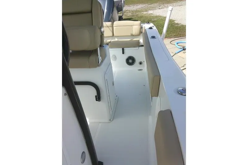 Slide: The Image of 2017 Sea Hunt Ultra 235 SE boat interior with beige seating and white deck. - 18