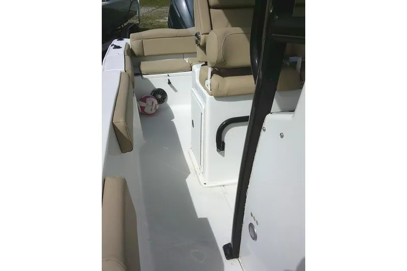 Slide: The Image of 2017 Sea Hunt Ultra 235 SE boat interior with beige seating and storage compartments. - 19