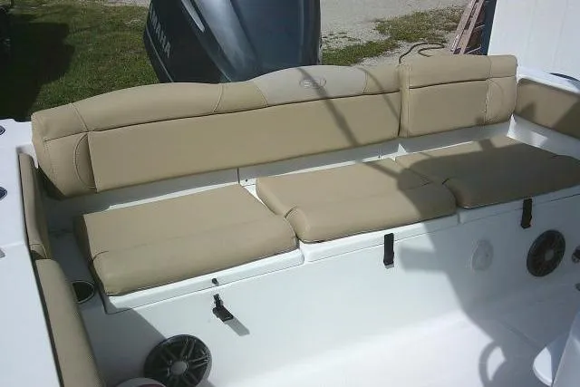 Slide: The Image of 2017 Sea Hunt Ultra 235 SE boat with beige cushioned seating and Yamaha engine. - 21