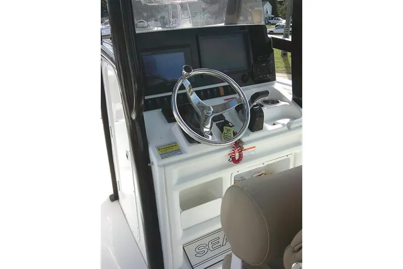 Slide: The Image of 2017 Sea Hunt Ultra 235 SE boat dashboard with steering wheel and navigation controls. - 22