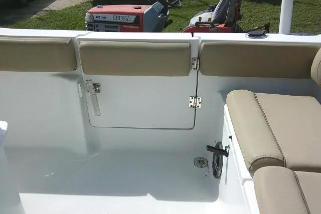 Slide: The Image of 2017 Sea Hunt Ultra 235 SE boat interior with beige seating and storage compartment. - 25