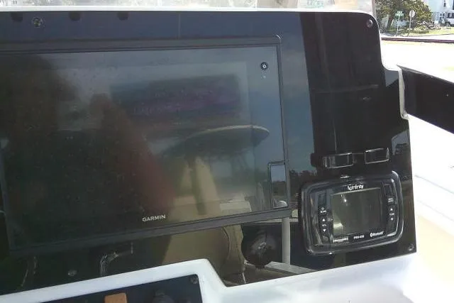 Slide: The Image of Control panel of a 2017 Sea Hunt Ultra 235 SE boat with Garmin and Simrad displays. - 28