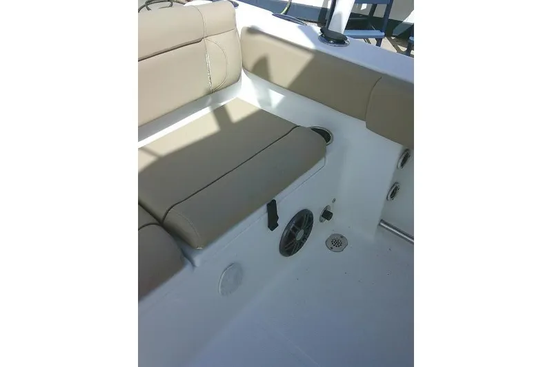 Slide: The Image of 2017 Sea Hunt Ultra 235 SE boat interior with beige seating and speaker. - 29