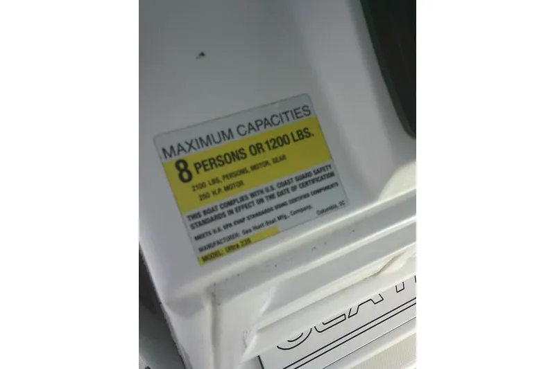 Slide: The Image of 2017 Sea Hunt Ultra 235 SE capacity label, maximum 8 persons or 1200 lbs. - 33