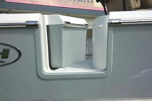 Slide: The Image of 2017 Sea Hunt Ultra 235 SE boat with open storage compartment. - 8