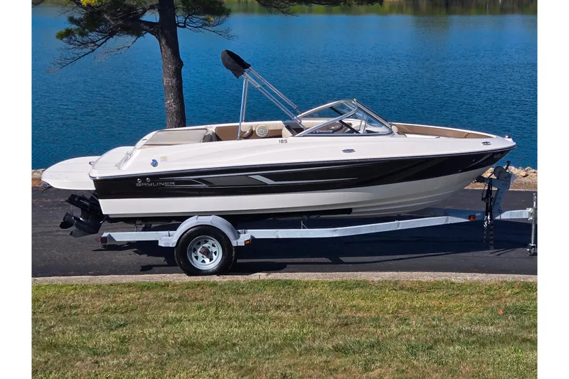 The Image of 2015 Bayliner 185 Bowrider on trailer by a serene lake. - 0