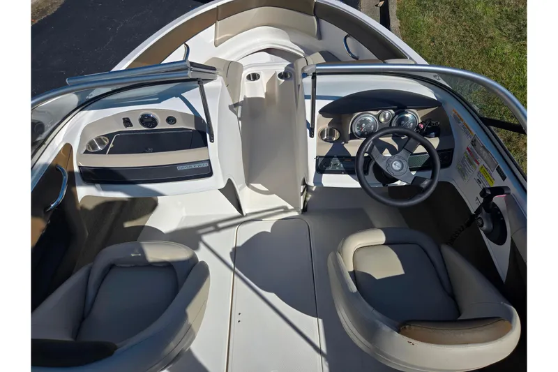 Slide: The Image of 2015 Bayliner 185 Bowrider interior with steering wheel, dashboard, and seating. - 11