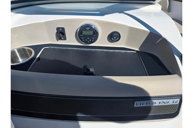 Slide: The Image of 2015 Bayliner 185 Bowrider dashboard with control panel and Bayliner logo. - 13