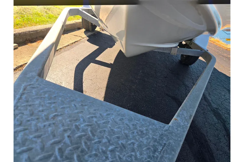 Slide: The Image of 2015 Bayliner 185 Bowrider on a trailer, parked on asphalt. - 7