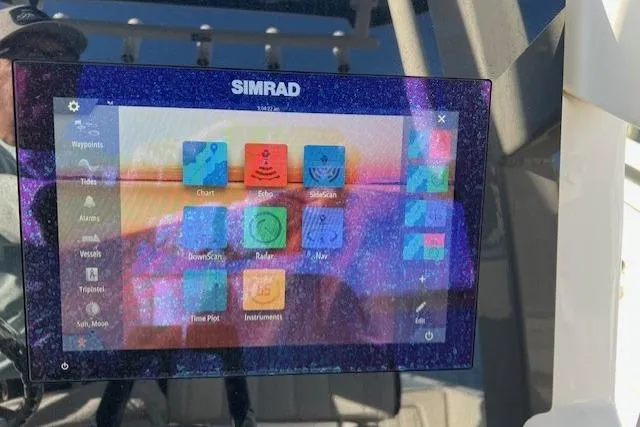 Slide: The Image of 2021 Yama 252 FSH Sport boat dashboard with steering wheel and controls. - 10