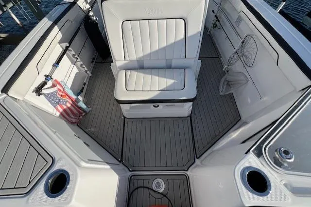 Slide: The Image of 2021 Yama 252 FSH Sport boat with white leather seating, close-up view. - 14