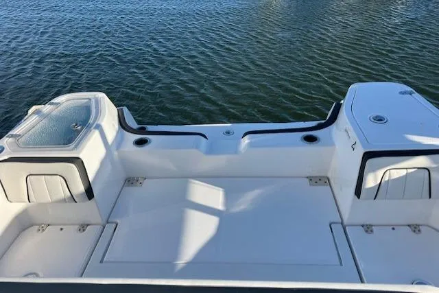 Slide: The Image of 2021 Yamaha Boats 252 FSH Sport interior with open storage compartments. - 20
