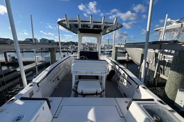 Slide: The Image of 2021 Yamaha Boats 252 FSH Sport on trailer, parked outdoors under cloudy sky. - 4