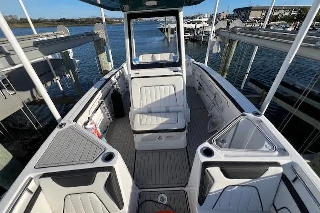 Slide: The Image of 2021 Yama 252 FSH Sport boat docked at marina under clear blue sky. - 6