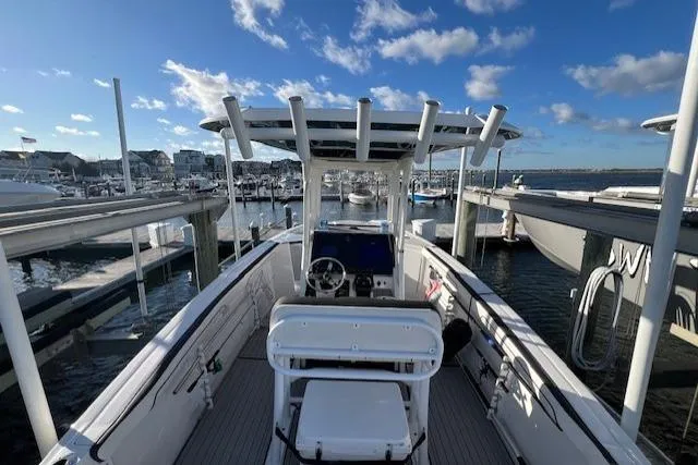 Slide: The Image of 2021 Yama 252 FSH Sport boat interior with seating, docked by the water. - 7