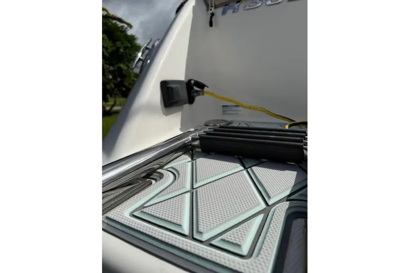 Slide: The Image of 2021 Robalo R300 Center Console boat deck with ladder and textured mat. - 11