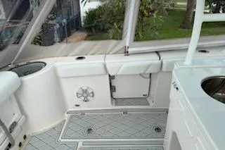 Slide: The Image of 2021 Robalo R300 Center Console boat interior with white seating and deck. - 14