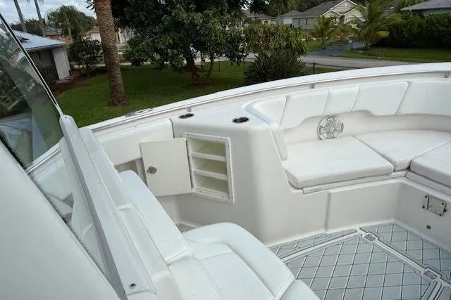 Slide: The Image of 2021 Robalo R300 Center Console boat interior with white seating and storage compartments. - 17