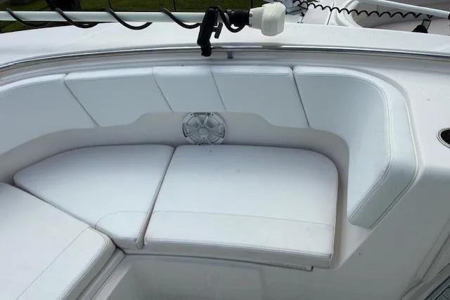 Slide: The Image of 2021 Robalo R300 Center Console boat with white cushioned seating area. - 21