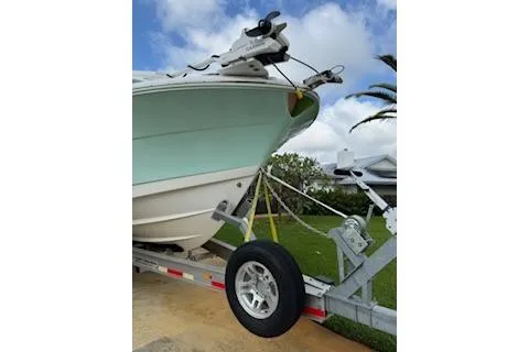 Slide: The Image of 2019 Robalo R300 Center Console boat on trailer, parked outdoors. - 24