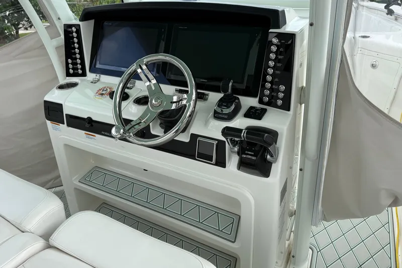 Slide: The Image of 2019 Robalo R300 Center Console helm with modern controls and dual displays. - 26
