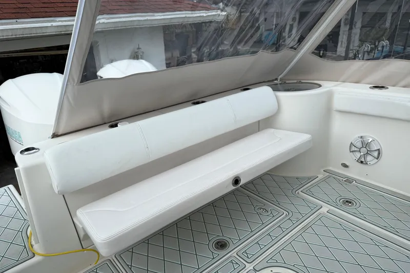Slide: The Image of 2019 Robalo R300 Center Console boat interior with white seating and deck. - 27