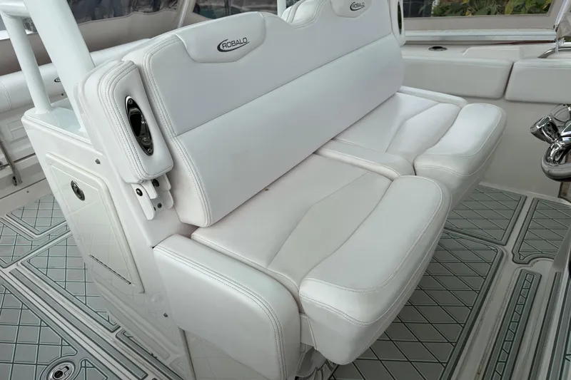 Slide: The Image of 2019 Robalo R300 Center Console boat with white cushioned seating and sleek interior design. - 28