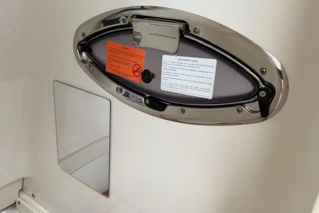 Slide: The Image of 2021 Robalo R300 Center Console boat hatch with safety instructions and warning labels. - 34
