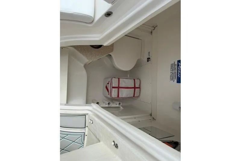 Slide: The Image of 2021 Robalo R300 Center Console interior cabin with storage and seating. - 36
