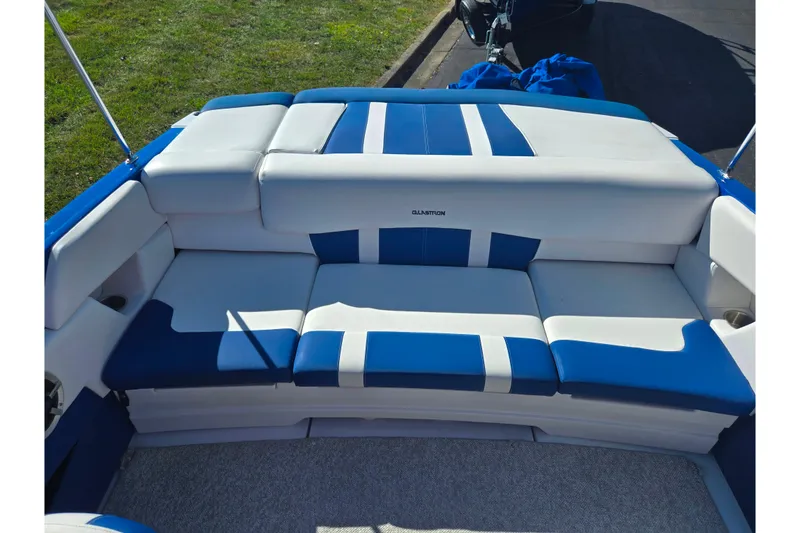 Slide: The Image of 2013 Glastron GT 205 boat interior with blue and white seating. - 23