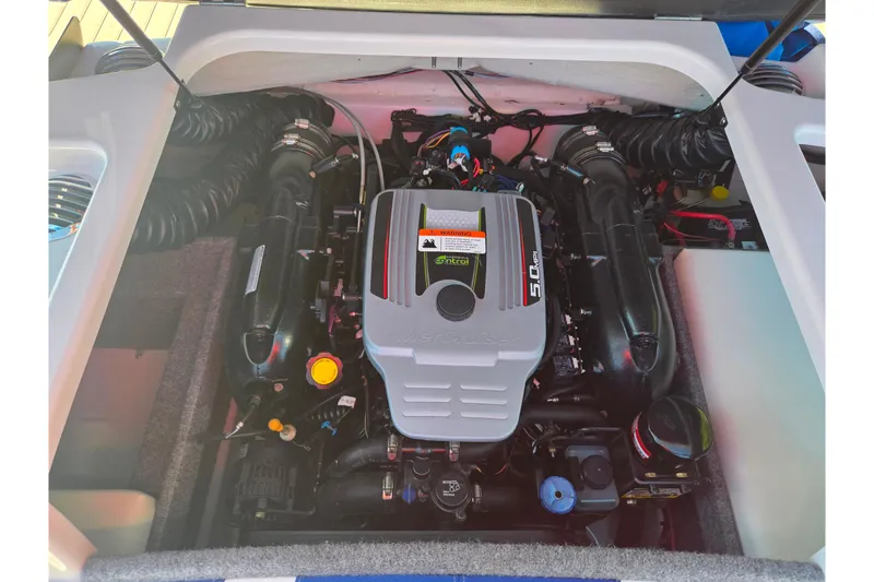 Slide: The Image of Engine compartment of a 2013 Glastron GT 205 boat, showcasing a 5.0L V8 engine. - 25