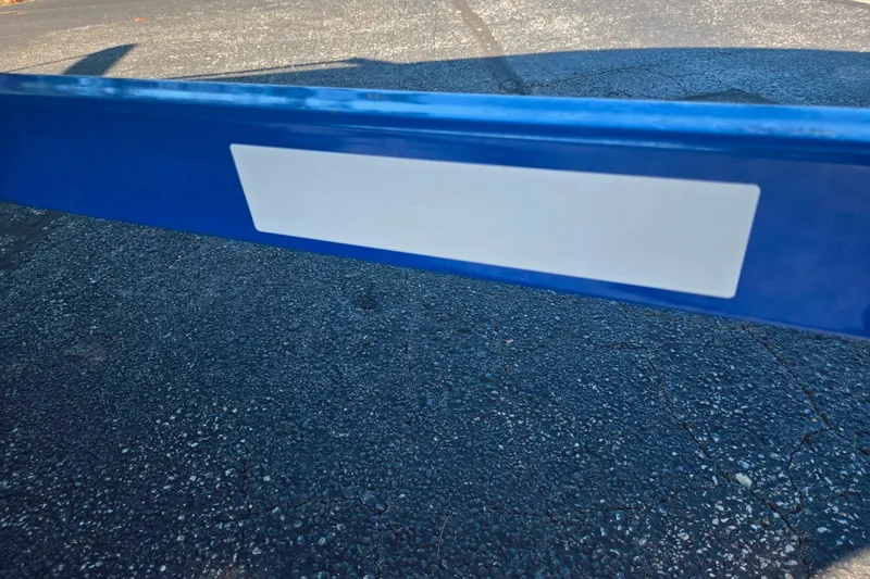 Slide: The Image of Blue Glastron GT 205 boat trailer, 2013 model, on asphalt surface. - 8