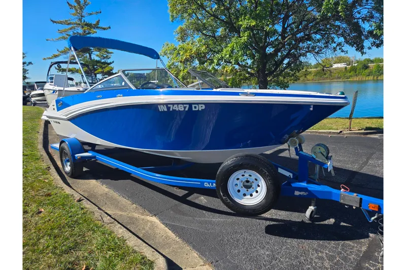 Slide: The Image of 2013 Glastron GT 205 boat on trailer by a lake, sunny day. - 9