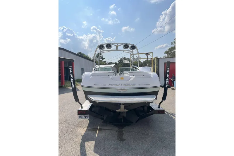 Slide: The Image of 2009 Nautique Super Air Nautique 230 boat, rear view, parked outdoors. - 3