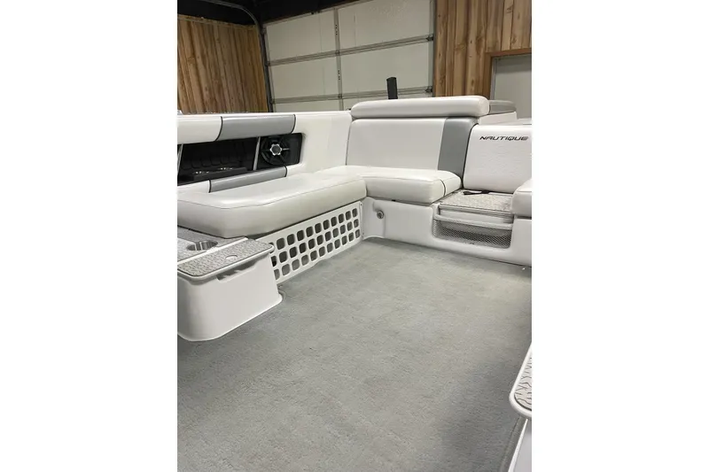 Slide: The Image of 2009 Nautique Super Air Nautique 230 interior with white and gray seating. - 6