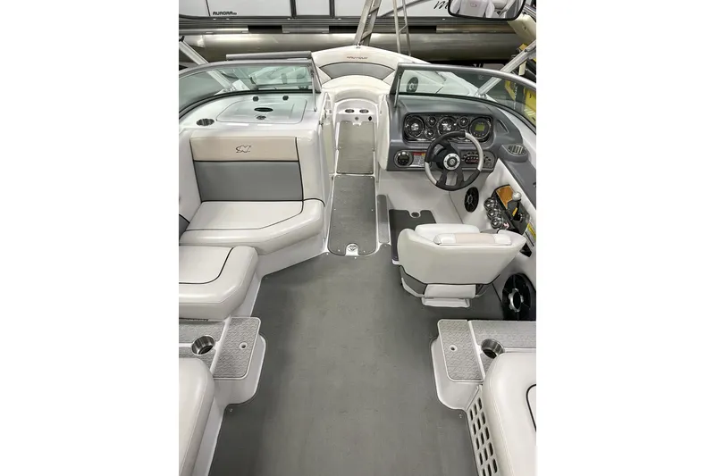 Slide: The Image of 2009 Nautique Super Air Nautique 230 interior with sleek seating and modern dashboard. - 8