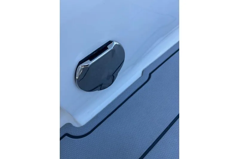 Slide: The Image of Close-up of a 2023 Chaparral 280 OSX boat's deck detail with chrome fitting. - 16