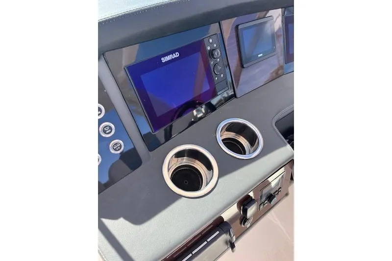 Slide: The Image of Dashboard of 2023 Chaparral 280 OSX boat with Simrad display and cup holders. - 18