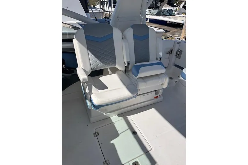 Slide: The Image of 2023 Chaparral 280 OSX boat interior with dual white and blue seats. - 4