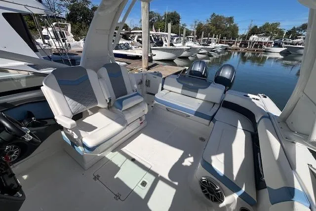 Slide: The Image of 2023 Chaparral 280 OSX boat interior with seating, docked at marina. - 5