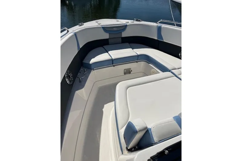 Slide: The Image of 2023 Chaparral 280 OSX boat interior with cushioned seating and sleek design. - 6