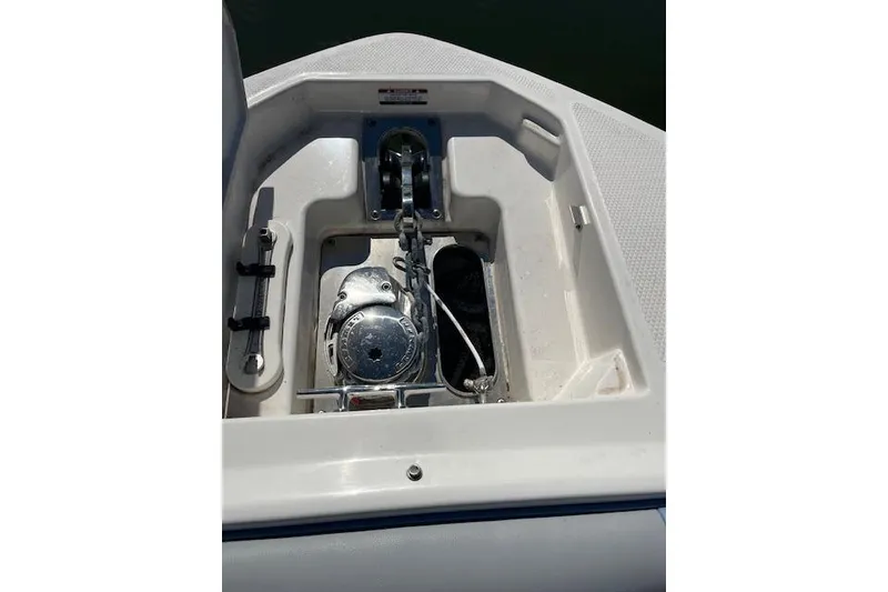 Slide: The Image of 2023 Chaparral 280 OSX boat anchor compartment with winch and cleat. - 7