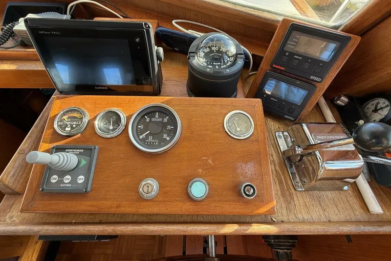 Slide: The Image of 1981 Marine Trader Double Cabin helm with gauges, compass, and navigation equipment. - 23