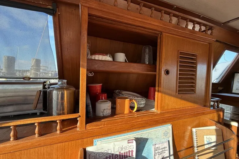 Slide: The Image of Interior of 1981 Marine Trader Double Cabin with wooden shelves and nautical decor. - 31