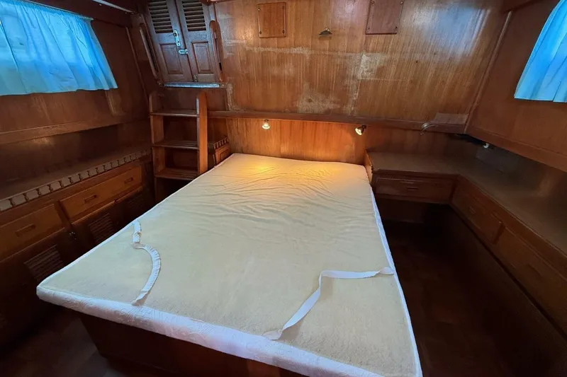 Slide: The Image of 1981 Marine Trader Double Cabin bedroom with wooden interior and bed. - 32