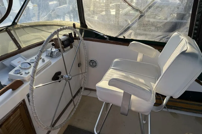 Slide: The Image of 1981 Marine Trader Double Cabin helm with steering wheel and captain's chair. - 42